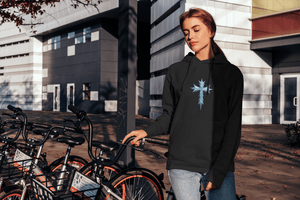 Woman outdoors in Icy Cross Hoodie with icy cross graphic, blending faith-based fashion with casual winter streetwear appeal.